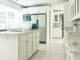 white wooden kitchen cabinet near white wooden door