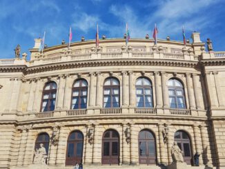 people in front of beige concrete building during daytime