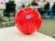 red soccer ball on white table