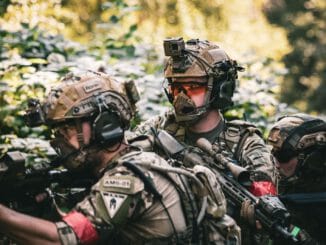 man in black and gray camouflage uniform wearing black helmet and black helmet