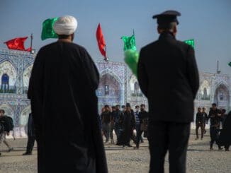 two men and a crowd in a plaza