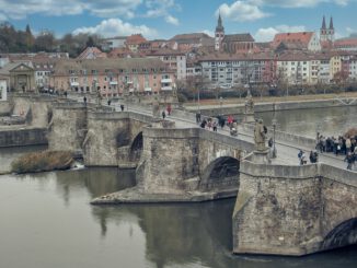 people walking on bridge over river during daytime
