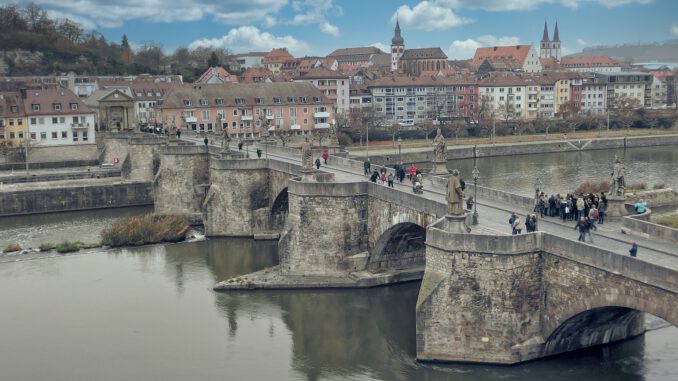 people walking on bridge over river during daytime