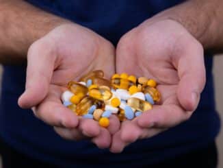 person holding medicine pills