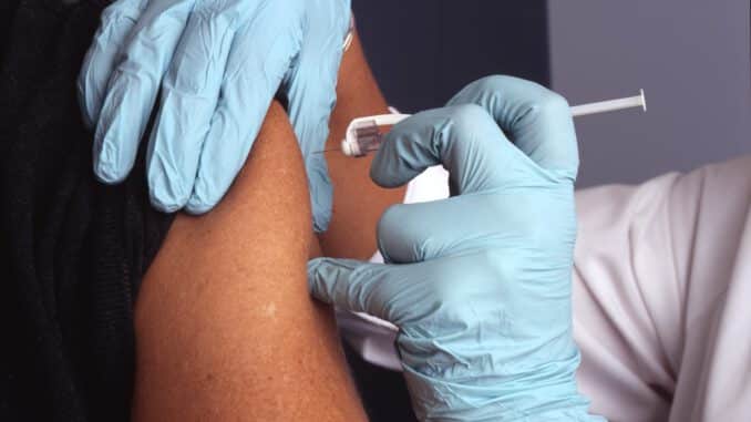 Photo by National Cancer Institute person in white gloves with blue textile on lap
