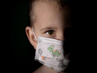 baby with white and green diaper